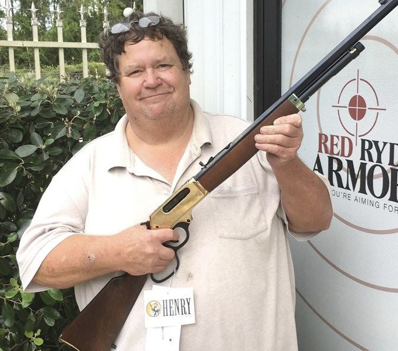 Man holding Henry BIG BOY lever action rifle in 45-70 Gov sold at Red Ryder Armory