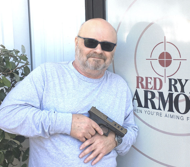 Man holding Custom 9mm GLOCK Model 19 Gen 4 sold at Red Ryder Armory