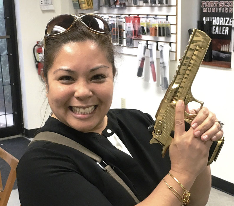 Woman holding 50 Caliber Desert Eagle pistol purchased at Red Ryder Armory in Jacksonville, Florida
